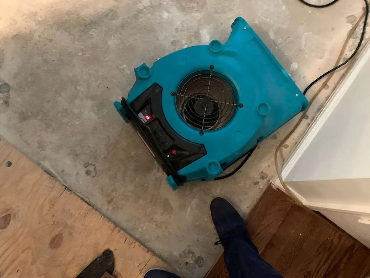 Air mover drying subfloor during Commercial Water Damage Restoration in Parma Heights
